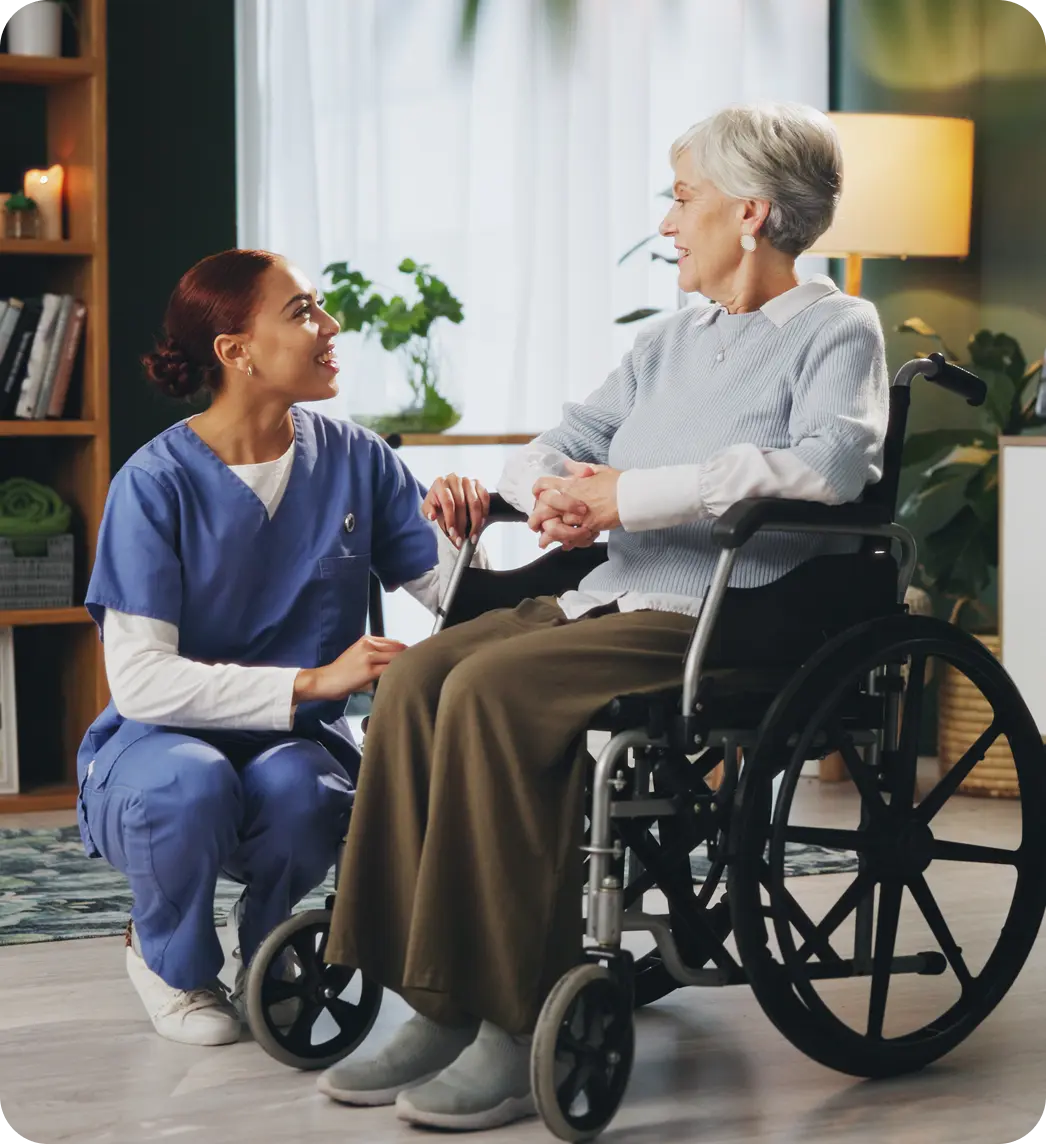 Carer supporting an older adult in a wheelchair