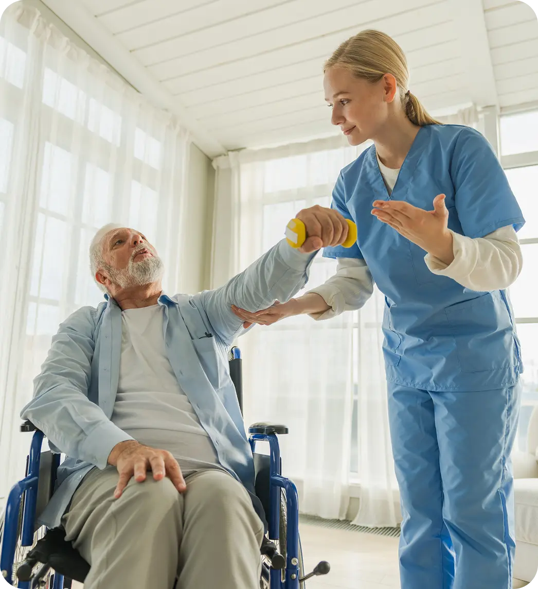 Carer supporting an older adult in a wheelchair